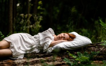 woman-sleeps-woods-pillow