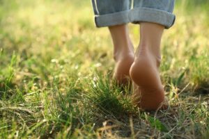 Woman,Walking,Barefoot,On,Green,Grass,Outdoors,,Closeup.,Space,For