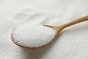 Wooden,Spoon,On,Granulated,Sugar,,Closeup,View