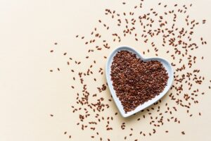 Whole,Flaxseeds,In,A,White,Heart,Shaped,Bowl,On,A