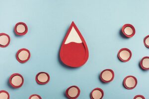 Drop,Of,Blood,And,Red,Blood,Cells,On,Pastel,Blue