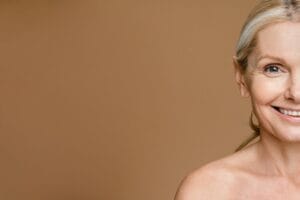 Beauty,Portrait,Of,Caucasian,Mature,Woman,Adjusting,Long,Hair,Behind